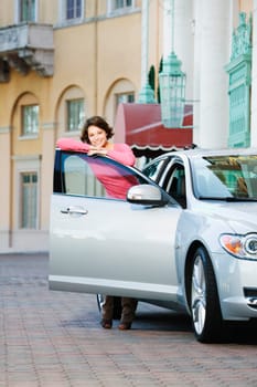 Woman leaning against a car door and smiling, Biltmore Hotel, Coral Gables, Florida, USA