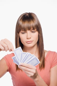 Close_up of a young woman playing cards