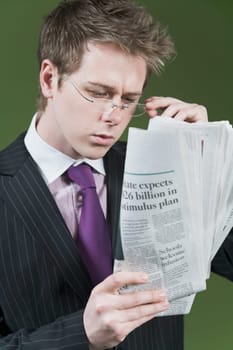 Close_up of a businessman reading a newspaper