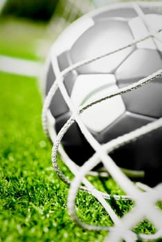 Close_up of a soccer ball in the net