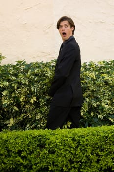 Businessman urinating in a formal garden and looking shocked, Biltmore Hotel, Coral Gables, Florida, USA