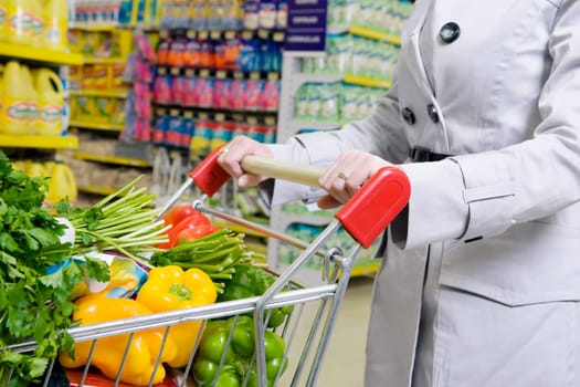 Woman shopping vegetables in a supermarket
