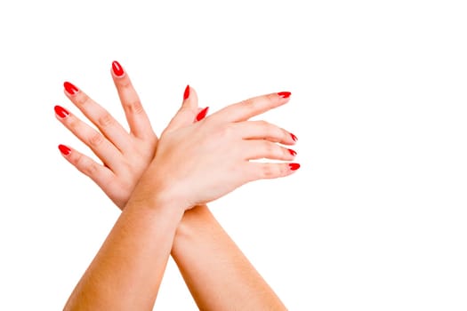 Cropped view of hands crossed at the wrists against a white background