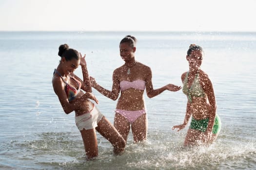 Teenage girl with her friends having fun on the beach