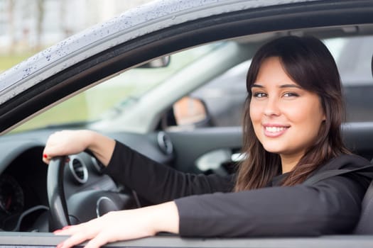 Business woman driving her new sports car