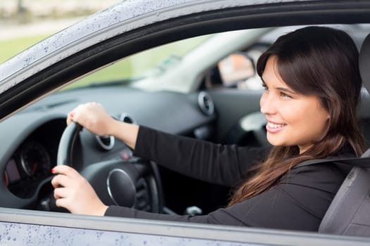 Business woman driving her new sports car