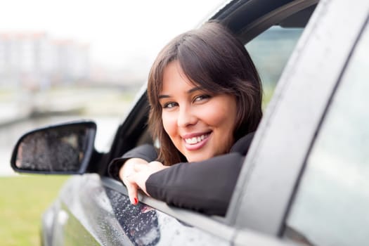 Business woman driving her new sports car