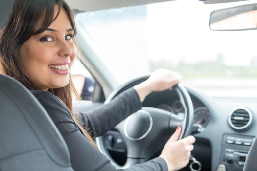 Business woman driving her new sports car
