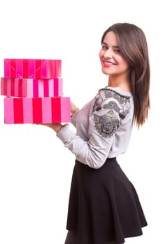 Studio shot of a young woman holding some gifts, isolated over white