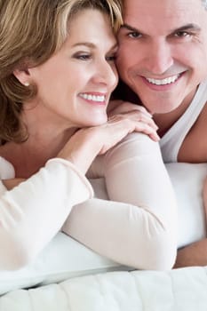 Couple lying on the bed and smiling