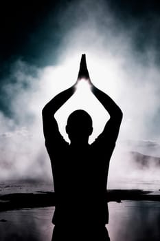 Silhouette of a person practicing yoga