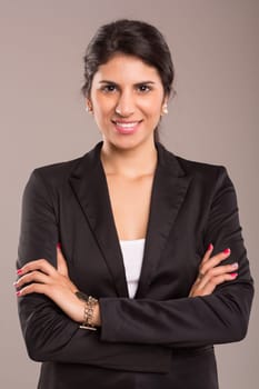 Beautiful young business woman posing isolated over copy space background