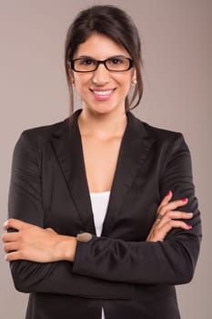 Beautiful young business woman posing isolated over copy space background
