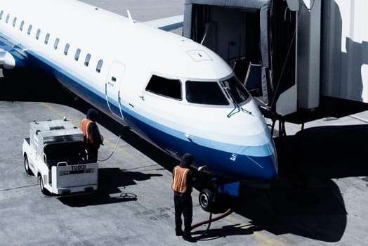 Airplane being refueled at an airport