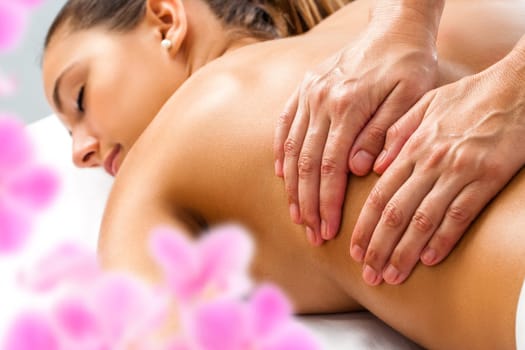 Close up of Hands doing Relaxing back massage on woman in spa.