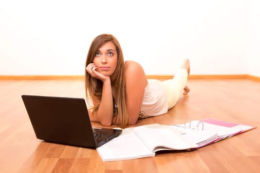 Beautiful teenager who wears braces, studying in her living room