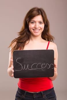 Young beautiful woman holding a small black board