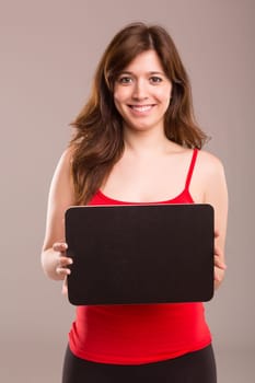 Young beautiful woman holding a small black board