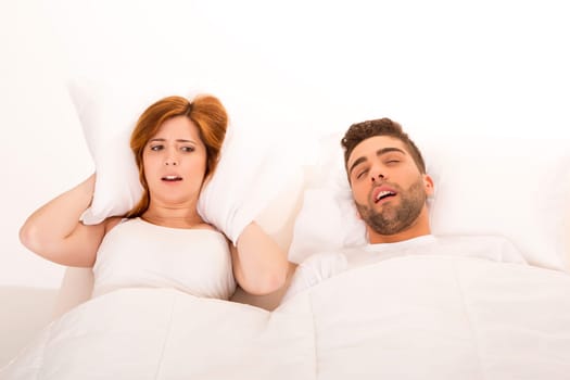 Portrait of an annoyed woman awaken by her fiance's snoring