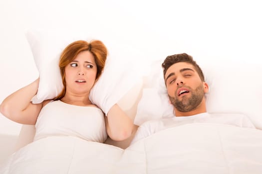 Portrait of an annoyed woman awaken by her fiance's snoring