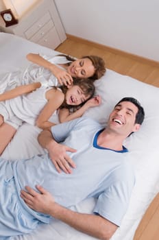 High angle view of a mid adult couple laughing with their daughter