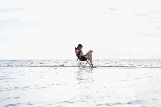 Side profile of a young woman sitting in a folding chair