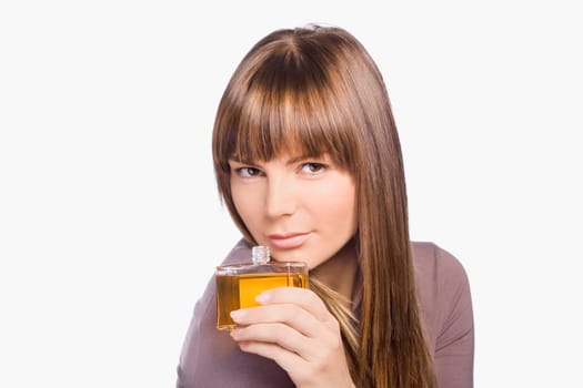 Portrait of a young woman smelling perfume
