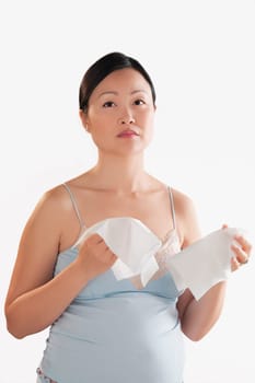 Portrait of a pregnant woman holding napkins