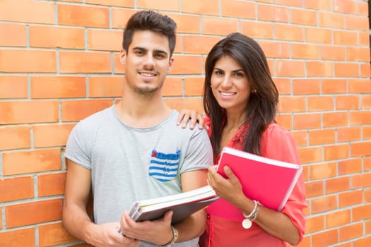 Couple of happy students at the university campus