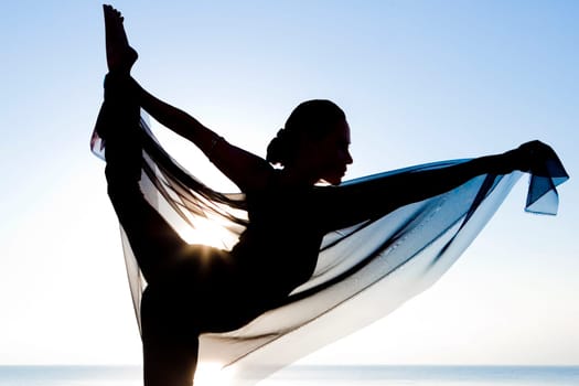 Silhouette of a woman practicing yoga