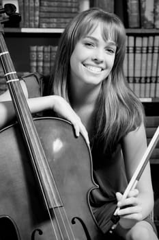 Woman playing a cello in a library