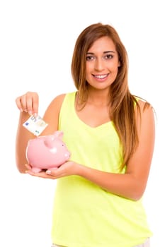 A teenager holding a piggy bank (money box) - savings concept
