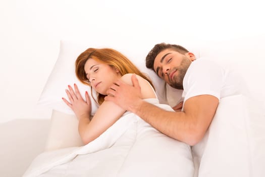 A beautiful young passionate couple in bed