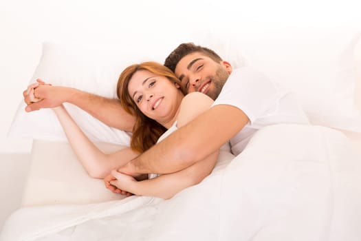 A beautiful young passionate couple in bed