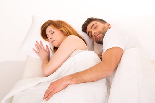 A beautiful young passionate couple in bed