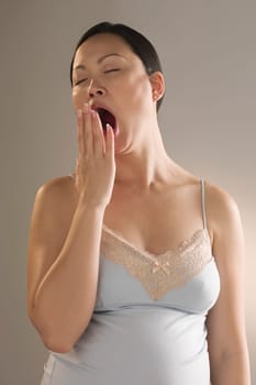 Close_up of a pregnant woman yawning