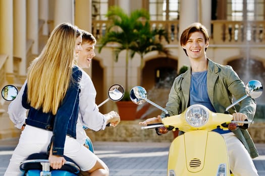 Three friends having fun on mopeds, Biltmore Hotel, Coral Gables, Florida, USA