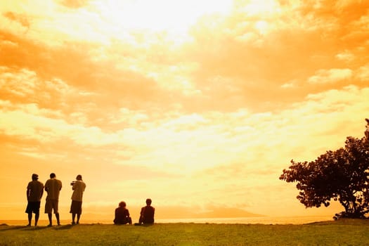 Rear view of five people on the beach, Tahiti, French Polynesia