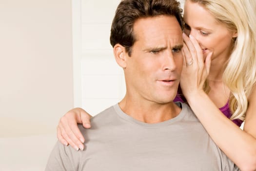 Woman whispering to a man