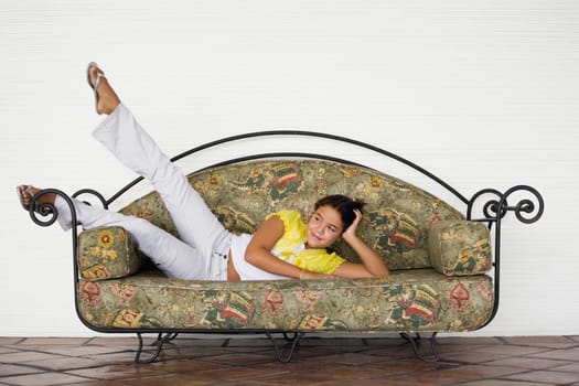 Girl lying on a couch and day dreaming