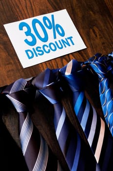 Ties displayed with a Discount sign in a clothing store
