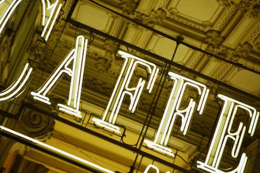 Close_up of neon cafe sign at a door, Genoa, Italy
