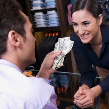 Man paying to a sales clerk in a clothing store