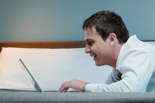 Close_up of a businessman working on a laptop and smiling