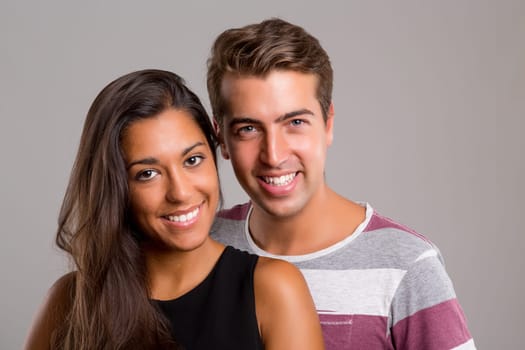 Young couple posing isolated in studio