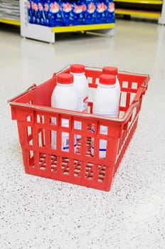 Bottles in a shopping basket in a supermarket