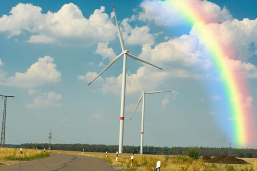 Sustainable green energy. Electric windmill generators in the sunrise