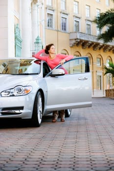 Woman leaning against a car and thinking, Biltmore Hotel, Coral Gables, Florida, USA