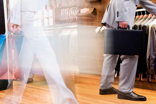 Businessman and a woman shopping in a clothing store