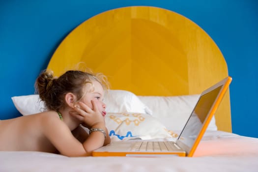 Baby girl looking at a laptop